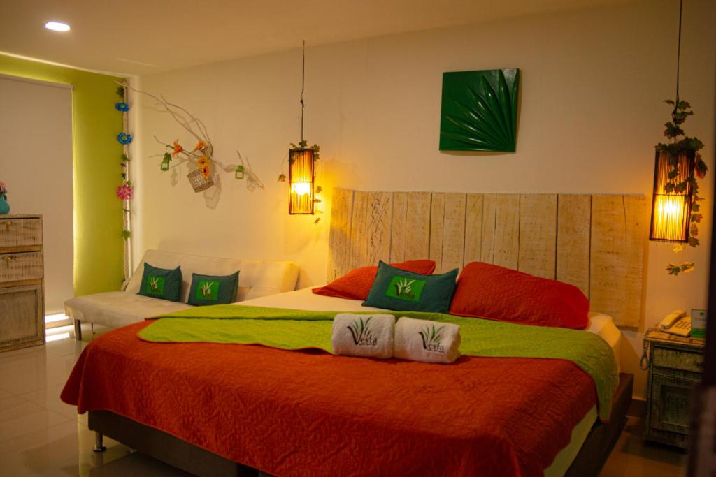 a bedroom with a bed with two towels on it at Hotel Vesta Boutique in Neiva
