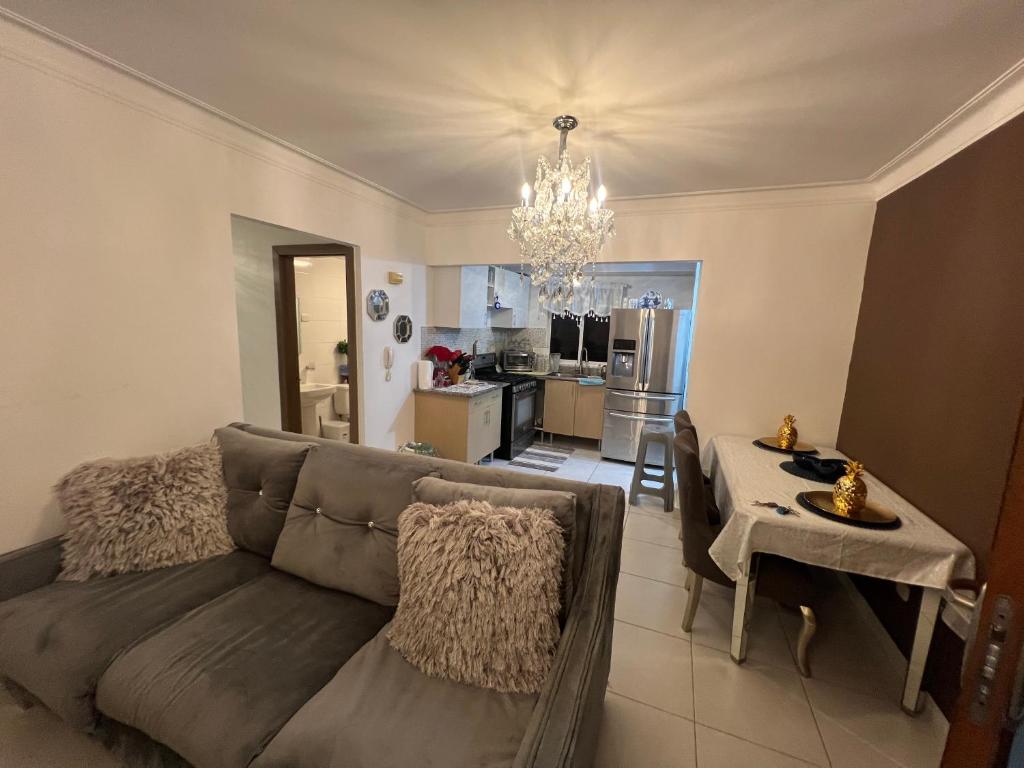 a living room with a couch and a kitchen at Residencial Terrazul in La Alianza