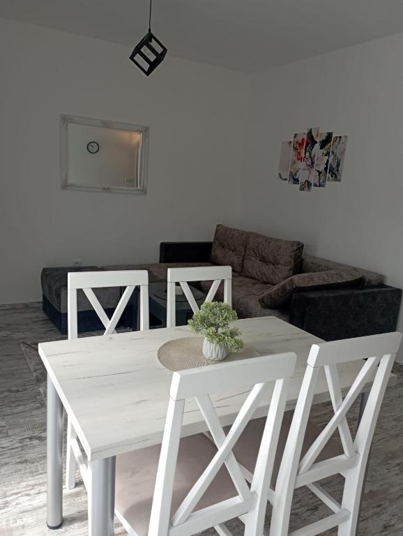 einen weißen Tisch und Stühle im Wohnzimmer in der Unterkunft Vila Leona D-1 in Divčibare