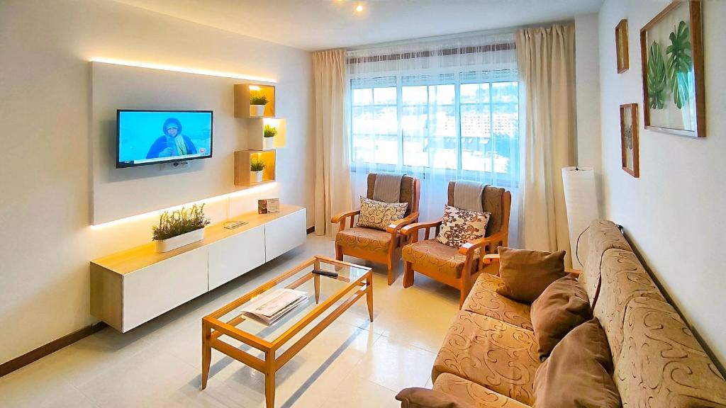een woonkamer met een bank en een tv bij Apartamento completo con wifi en Betanzos in Betanzos