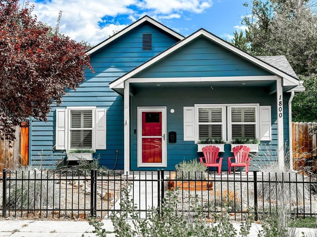 a blue house with red door and red chairs at Remodeled Downtown 3bed Home Quartz Countertops in Boise