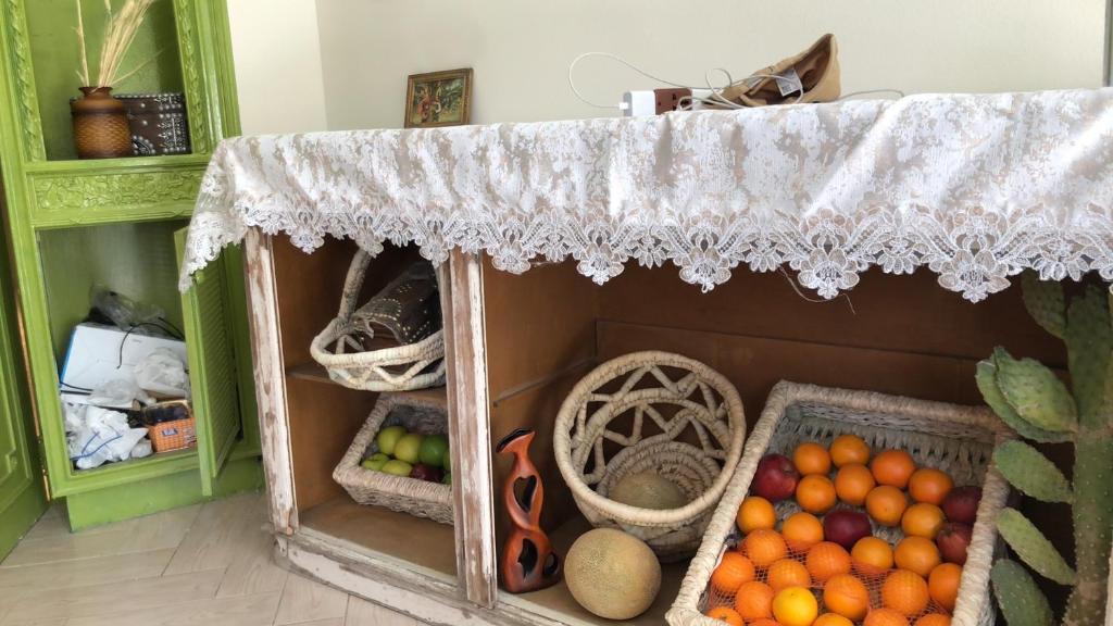 a cabinet filled with lots of fruits and vegetables at TUTUhouse in Cairo