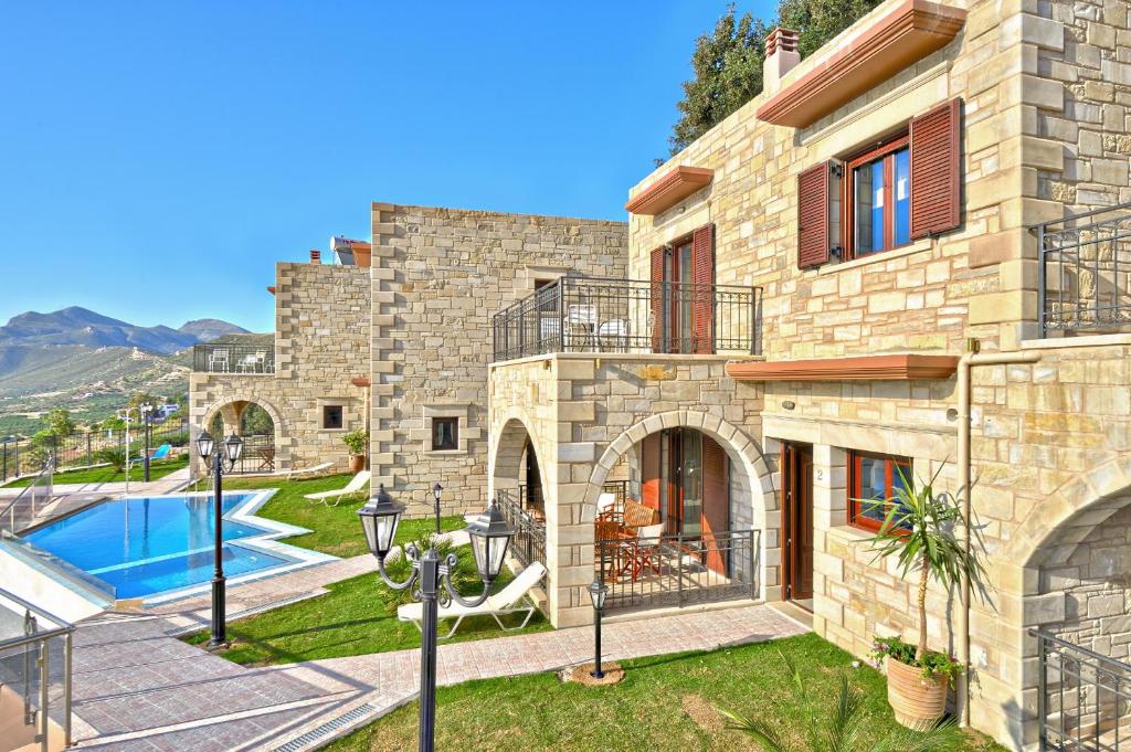 a large stone house with a swimming pool at Fotini Traditional Villas in Kavoúsion