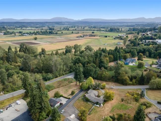 an aerial view of a house in a field at Pet Friendly and Spacious Valley View Family Home in Snohomish