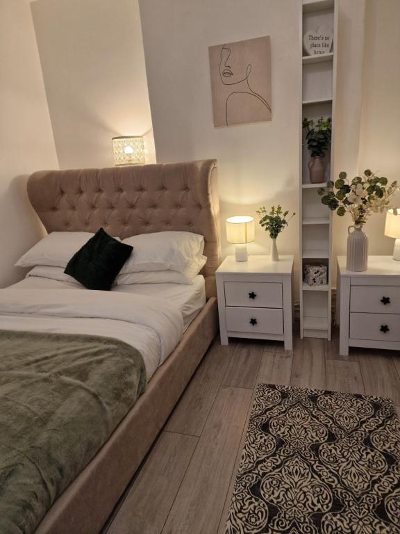 a bedroom with a large bed and two night stands at 1 bedroom flat London in London