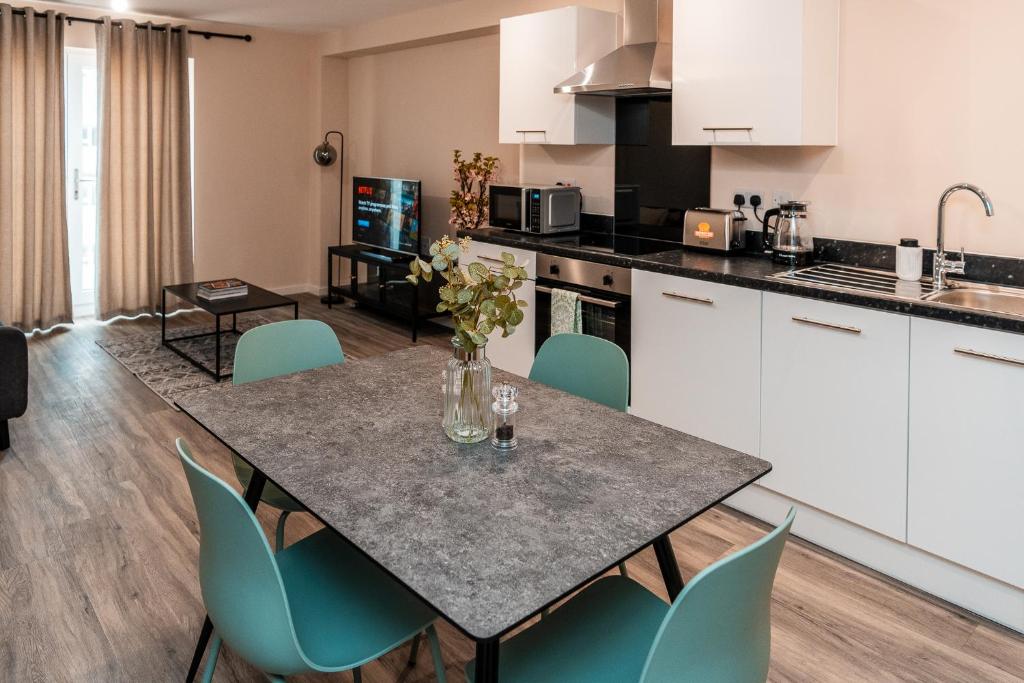 a kitchen and dining room with a table and chairs at Entire 2 Bedroom and 2 Bathroom Apartment in Manchester City -Free underground Parking in Manchester