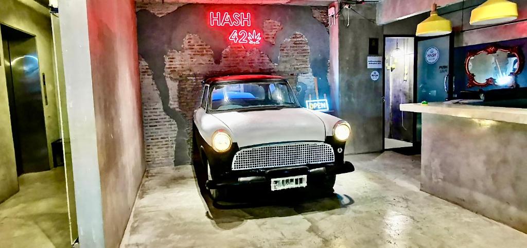 an old car is parked in a room at Hash Silom Apartment @ Silom Soi 3 in Bangkok