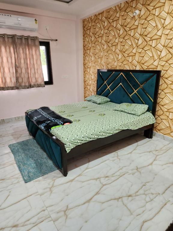 a bedroom with a bed in a room at Manidweepa farm house in Venkatāpur