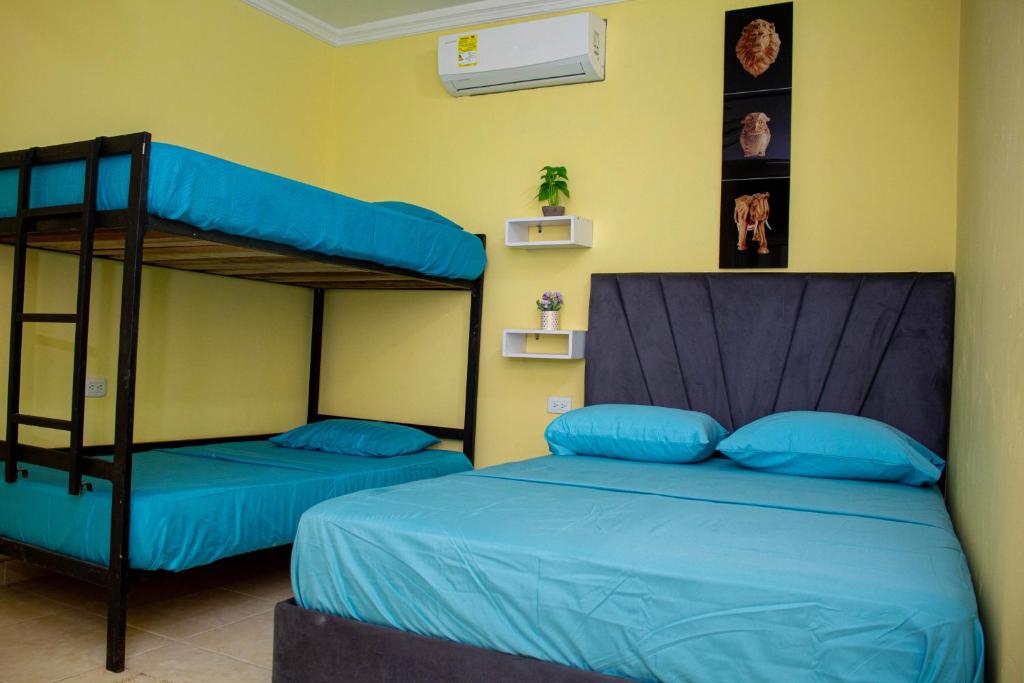 a bedroom with two bunk beds with blue pillows at Comfort House in Santa Marta