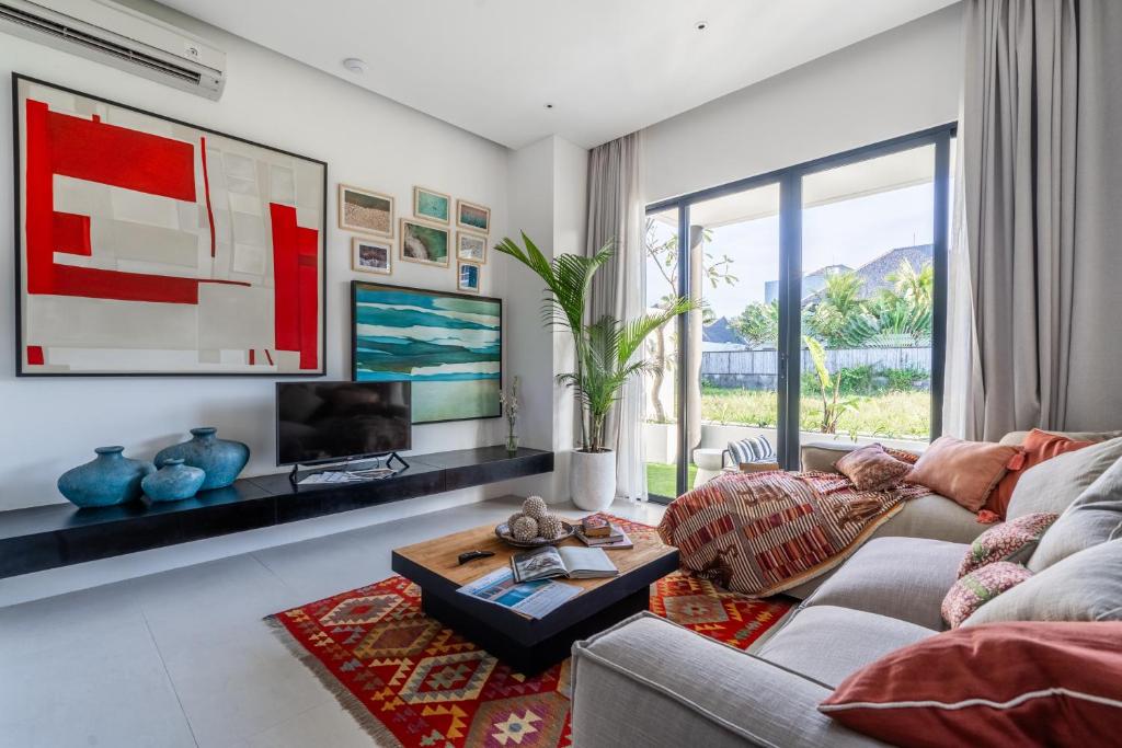 a living room with a couch and a table at Mandala Residences in Canggu