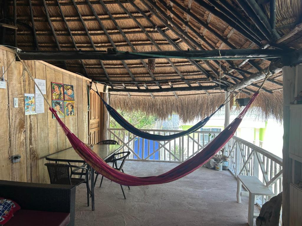 a hammock in a room with a table and chairs at Eco-Conscious Oasis Punta Arena 04 in Playa Punta Arena