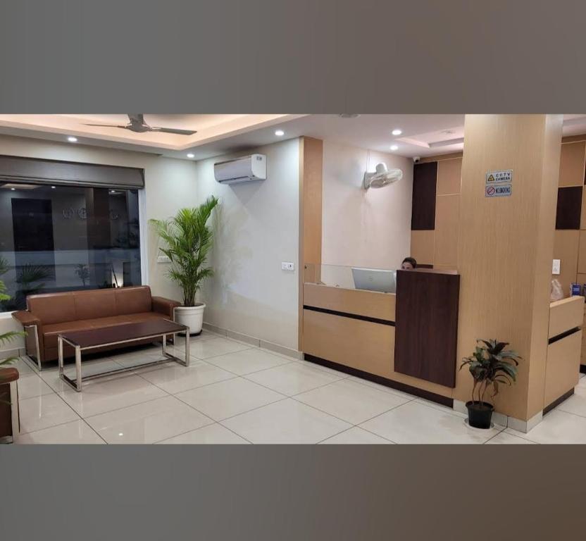 an office lobby with a couch and a table at HOTEL FLAMINGO in Jaipur