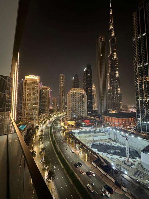 a view of a city at night with traffic at Burj Crown 2BR Apartment with Panoramic Burj Khalifa View in Dubai
