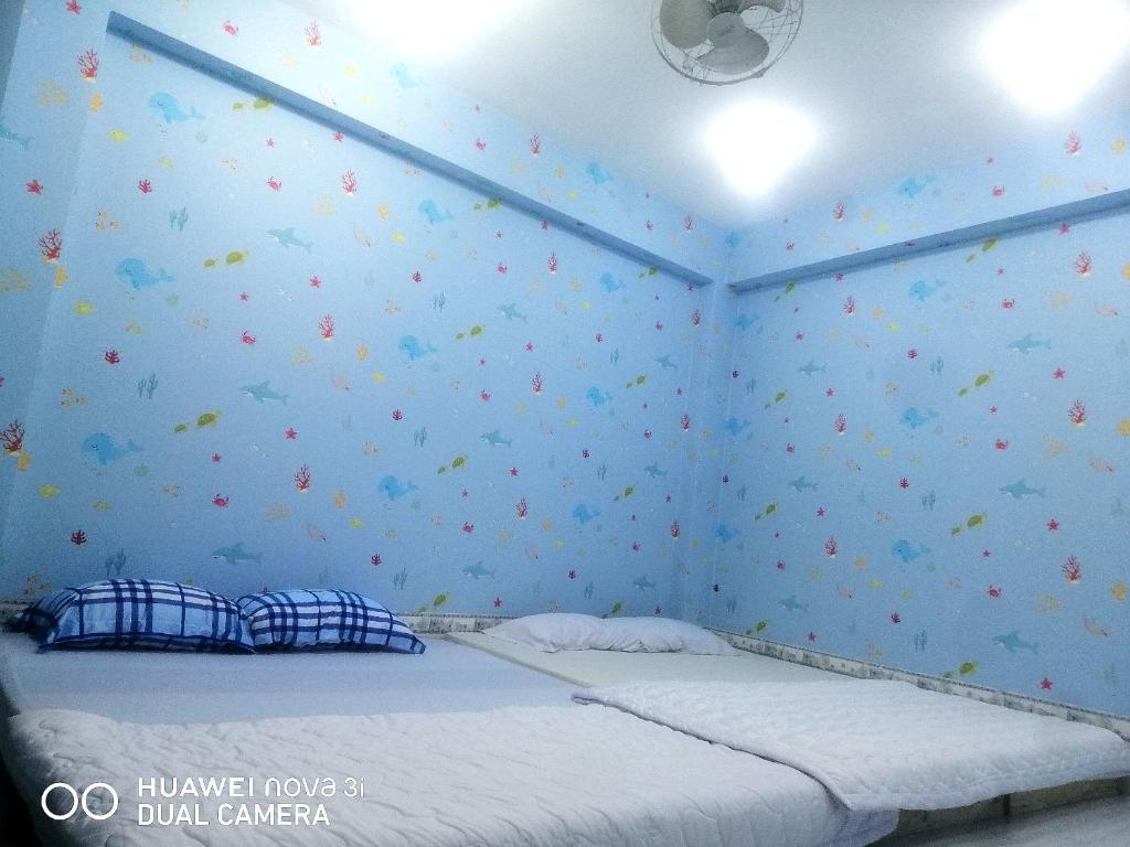 Postel nebo postele na pokoji v ubytování NHÀ NGUYÊN CĂN VŨNG TÀU DUNGVINH'S HOME