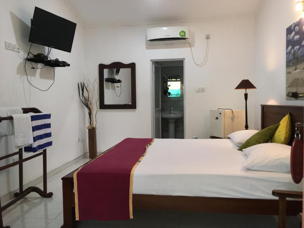 Postel nebo postele na pokoji v ubytování Ceylonika Rest