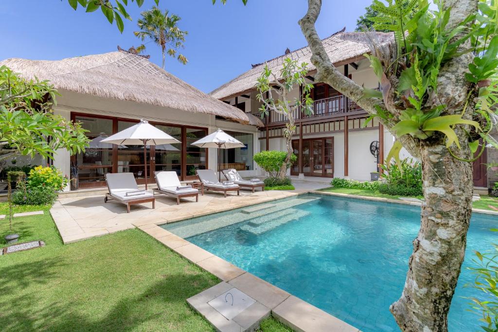an image of a villa with a swimming pool at Villa Dorado - Steps from Jimbaran Beach in Jimbaran