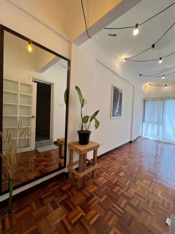 a room with a potted plant on a wooden floor at The Brooklyn in Bentong