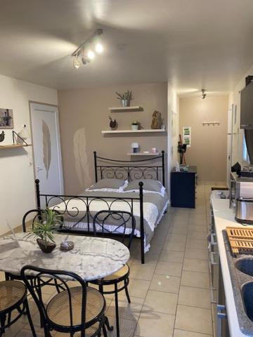 a bedroom with a bed and a table and chairs at Cottage a la campagne avec piscine et SPA in Ardentes