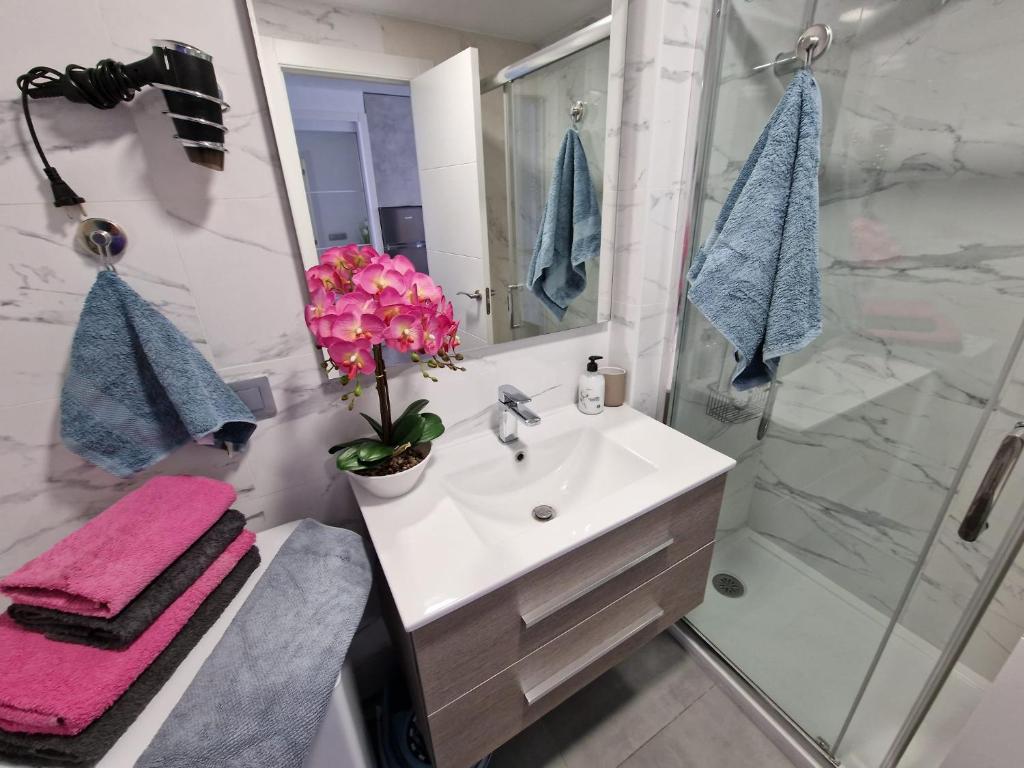 a bathroom with a sink and a shower at Playa Poniente Benidorm in Benidorm