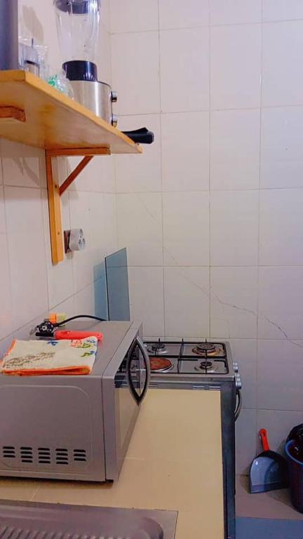 a kitchen with a stove and a counter top at Appart boa in Cotonou