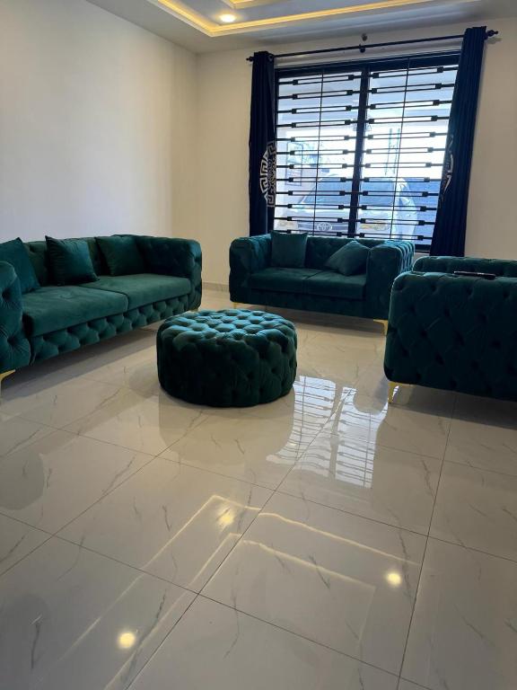 a living room with green couches and a couch at Superior Villa in Mirpur city Azad kashmir 