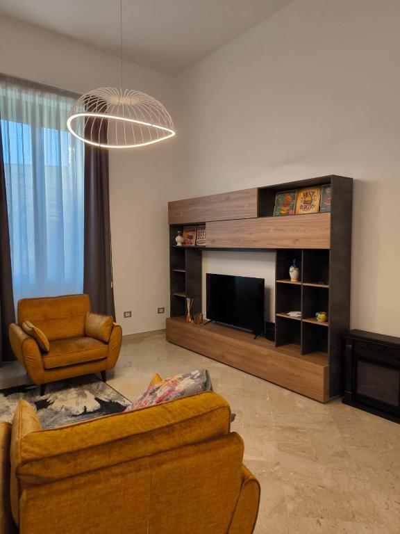 a living room with a couch and a television at La Casa Rossa in Brindisi