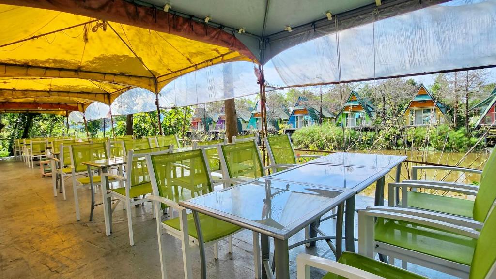 a row of tables and chairs with umbrellas at Kitefarm in Dongshan