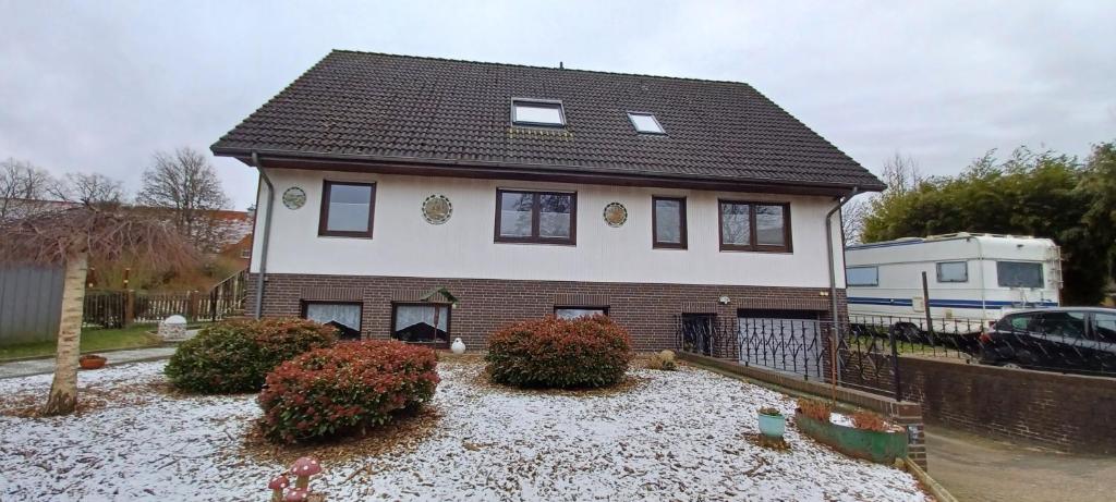 a white house with a brown roof at Sonja gemütliche Ferienwohnung in Bruchhausen-Vilsen