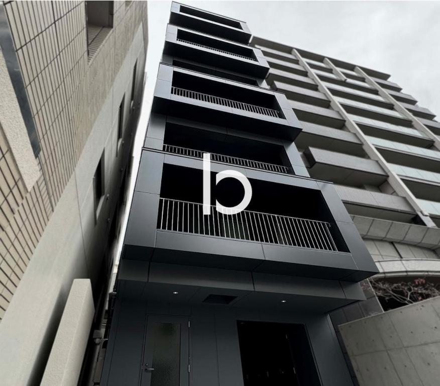 a building with the letter p on the side of it at bHOTEL Rijodori - Stylish Studio Apartment in Vibrant Hiroshima in Hiroshima