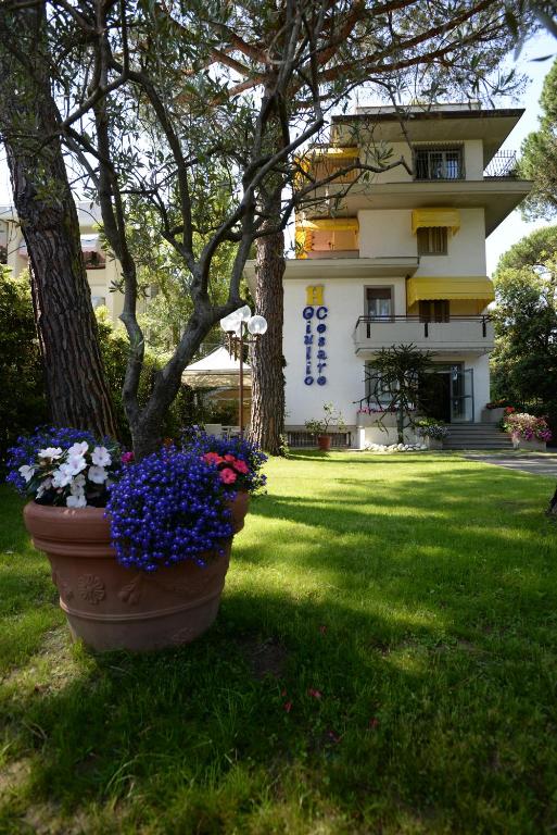 a large pot of flowers in front of a building at Hotel Giulio Cesare in Cinquale