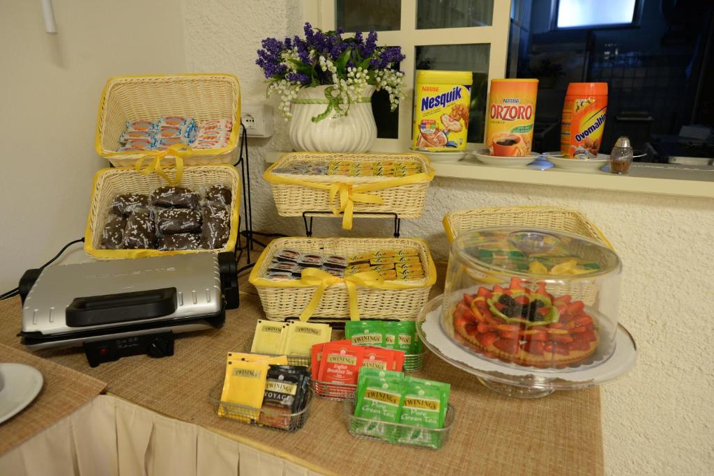 a counter with baskets and food on a table at Hotel Giulio Cesare in Cinquale