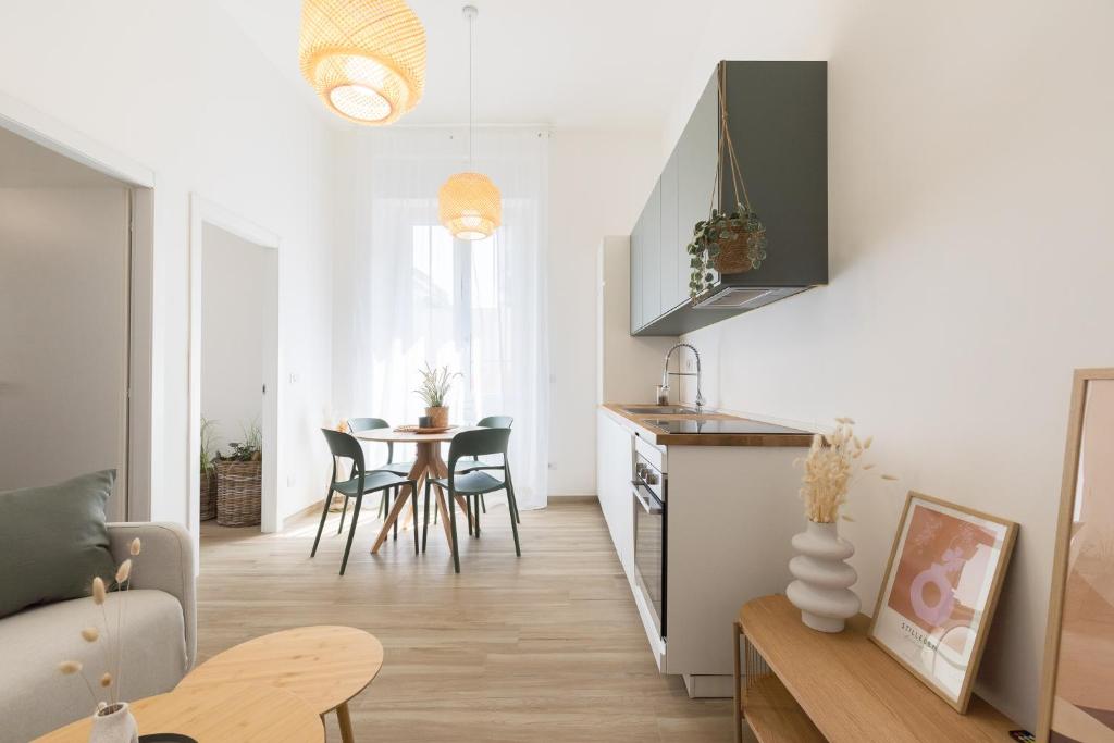 a kitchen and living room with a table and chairs at Luni 4 - Design trilo suite -M3- 8 min dal Duomo in Milan