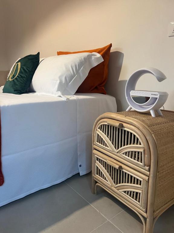 two beds with pillows and a basket in a room at Domus Orestea Luxury Suites in Palermo