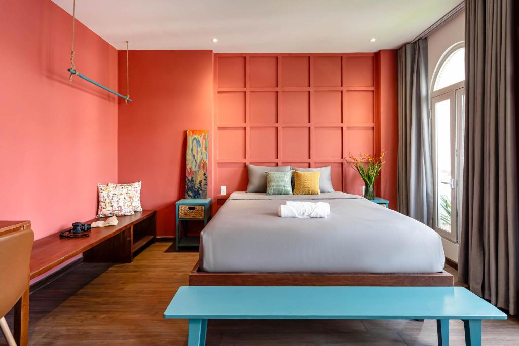 a bedroom with red walls and a large bed at Mersey Central Saigon Apart'Hotel in Ho Chi Minh City