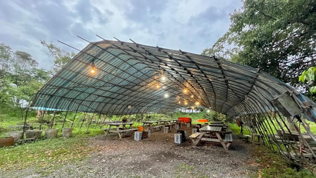 a group of picnic tables under a tent at Kitefarm in Dongshan