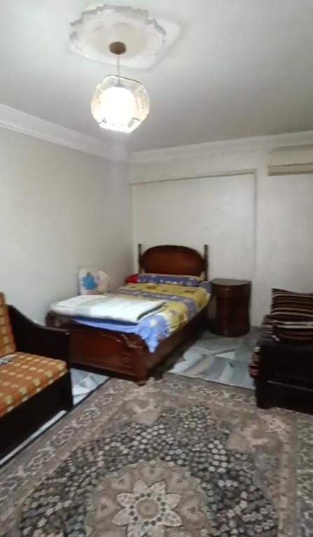 a bedroom with a bed and a couch in a room at الاسكندرية المندرة بحرى in Alexandria