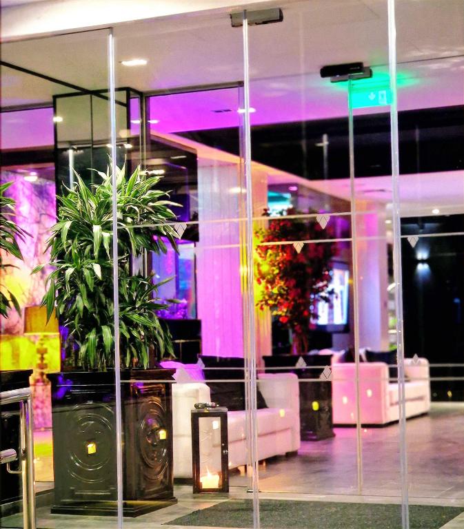 a room with plants in a building with purple lights at The Ciao Stelio Deluxe Boutique Hotel - Adults Only in Larnaka
