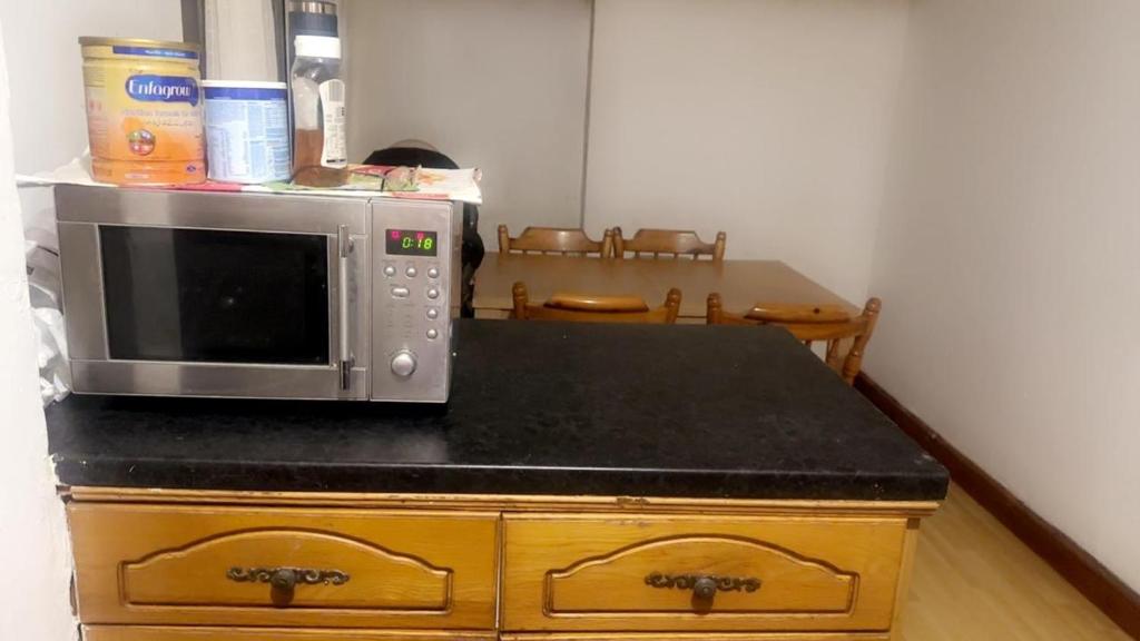 a microwave oven sitting on top of a counter at Numan’s guest house in Coundon