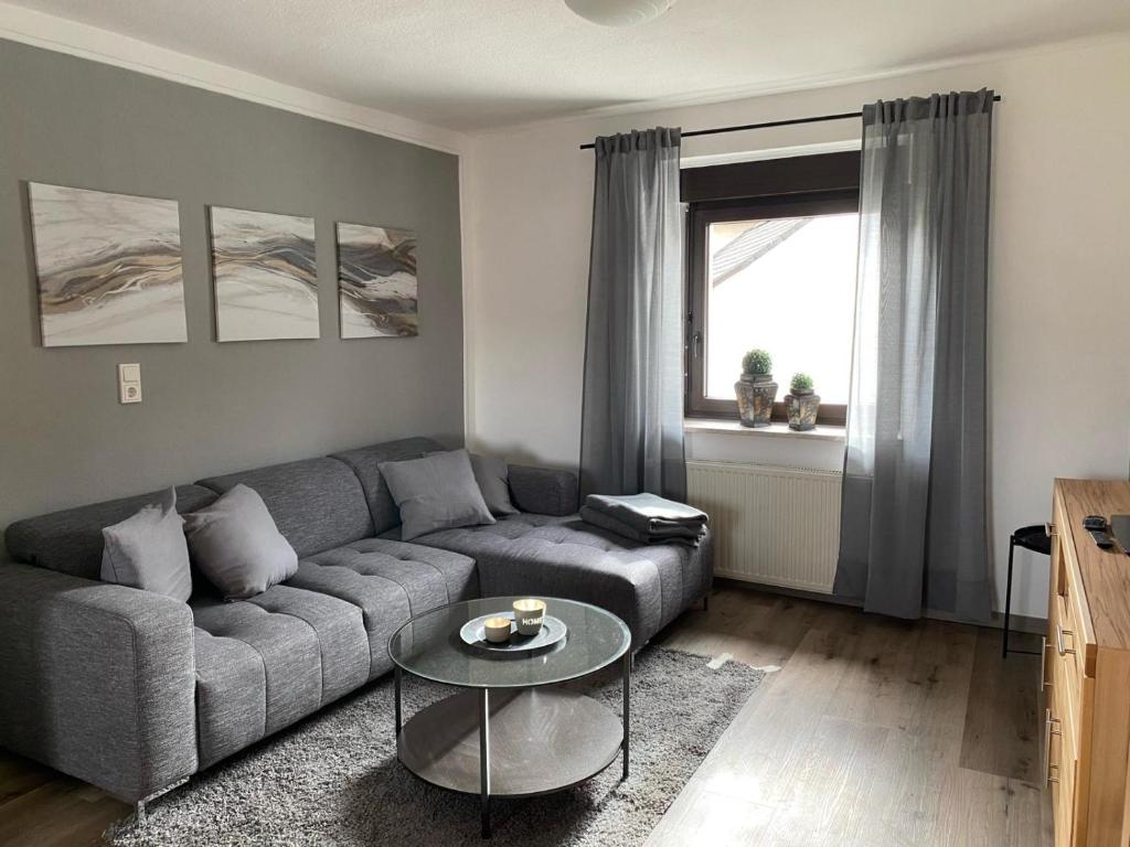 a living room with a couch and a table at Ferienwohnung Burgberg in Stadtkyll