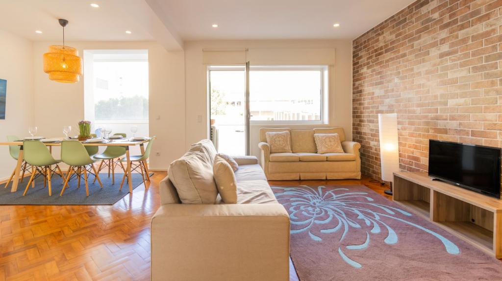 a living room with a couch and a table at Charming Bessa Apartment by Unique Hosts in Porto