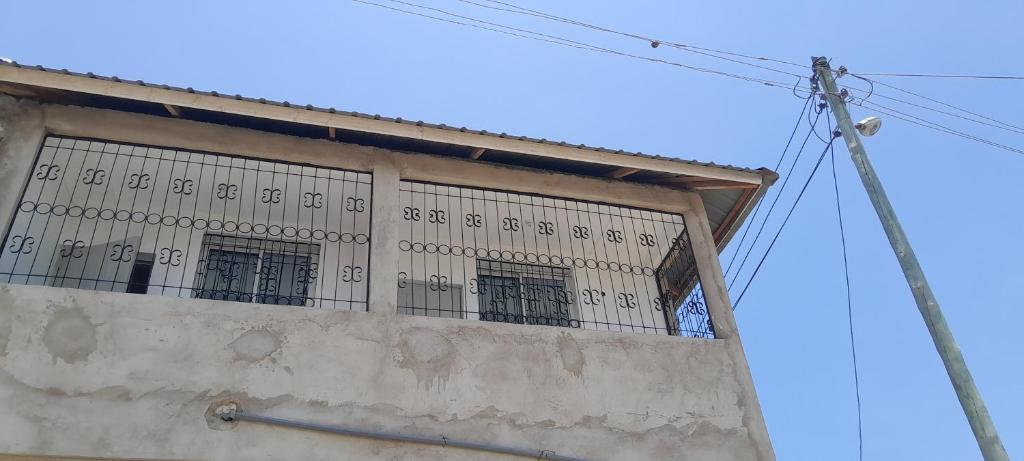 a building with barred windows on the side of it at Saloome Accommodation Mikindani in Mombasa