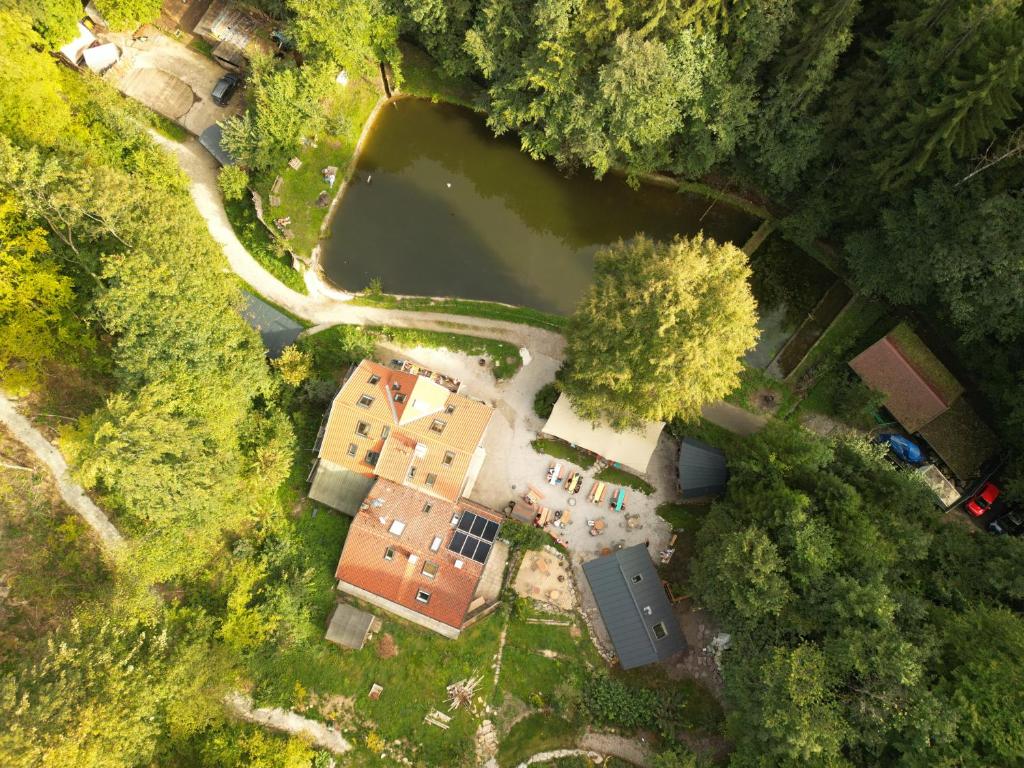 an overhead view of a house and a lake at Waldschlucht in Bad Kohlgrub