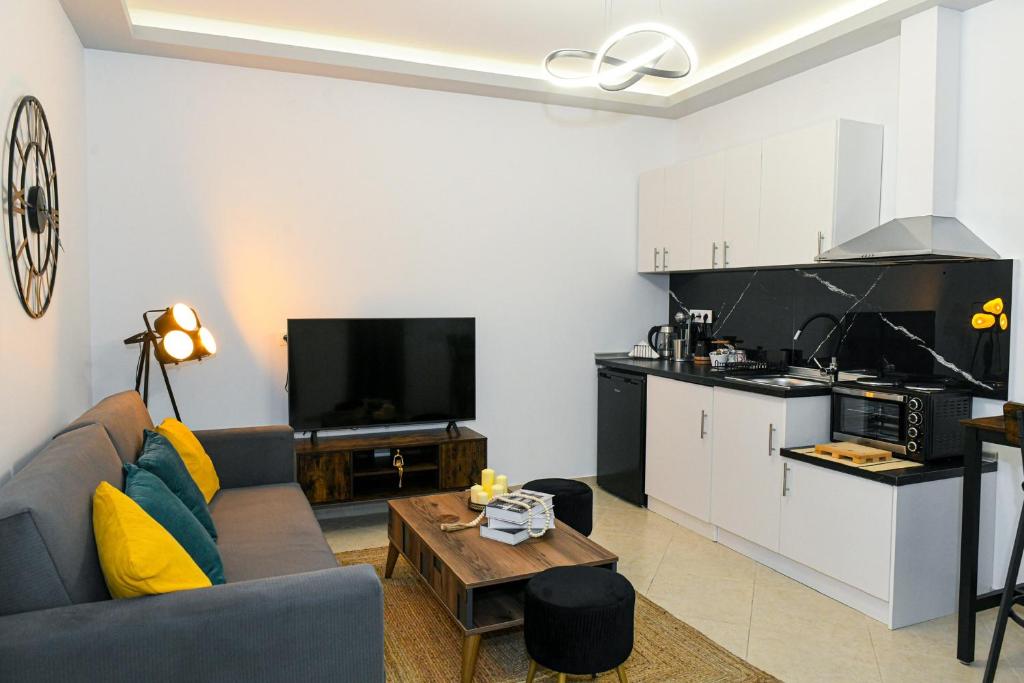 a living room with a couch and a kitchen at Sias Apartment in Alexandroupoli