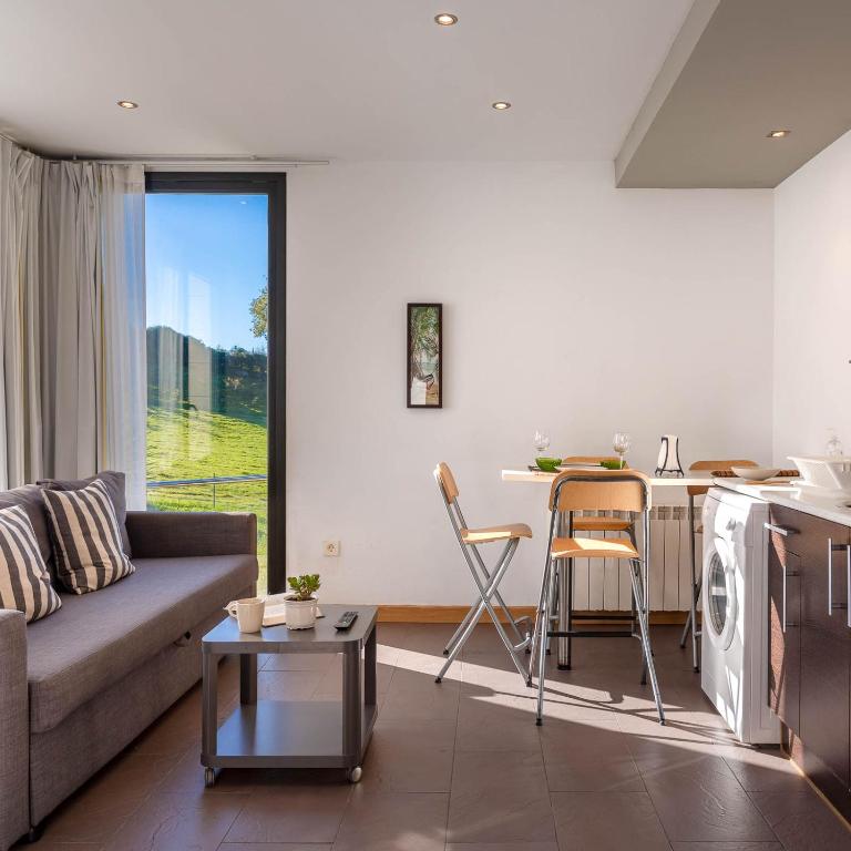 a living room with a couch and a table at Apartamentos Naredo in Villaviciosa