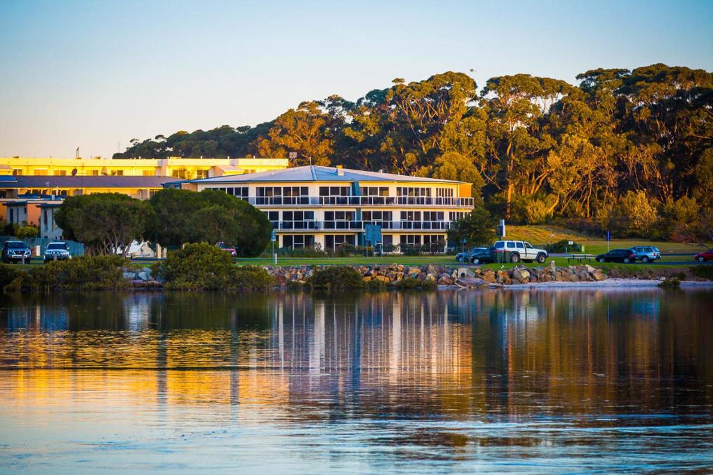 a large building next to a large body of water at Waterview Luxury Apartments in Merimbula
