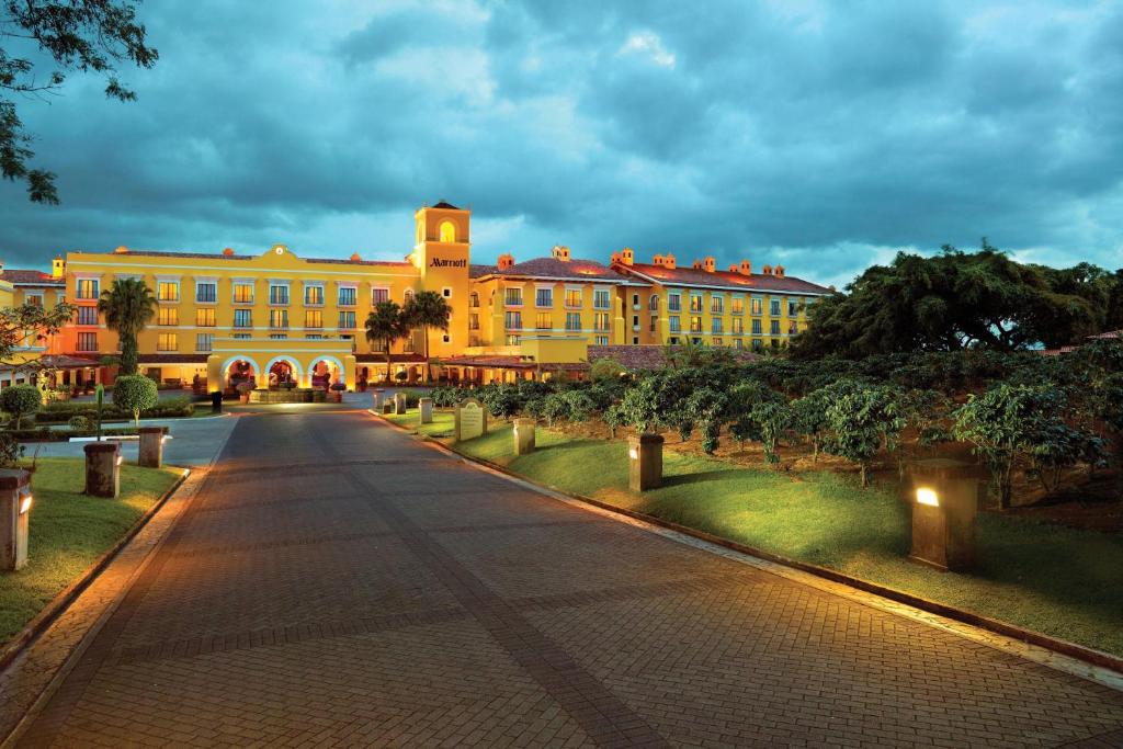 a large yellow building with a street in front of it at Costa Rica Marriott Hotel Hacienda Belen in San José