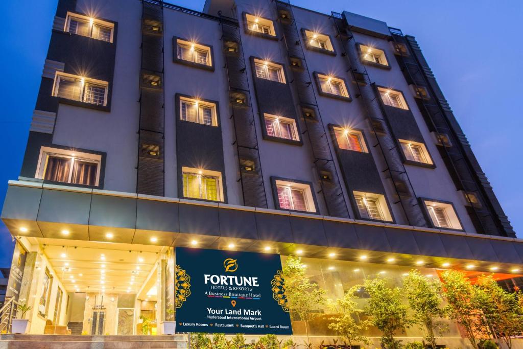 a tall building with a sign in front of it at Hotel Fortune Hyderabad Airport Zone in Hyderabad