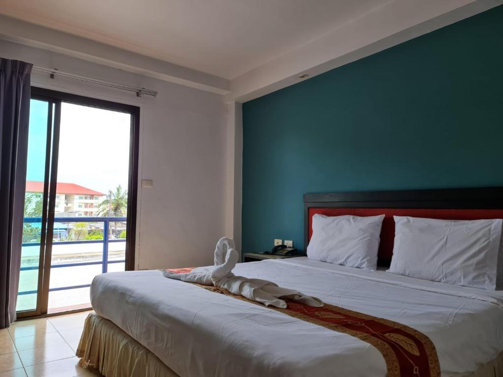 a bedroom with a bed with a stuffed animal on it at Desa Phuket in Phuket