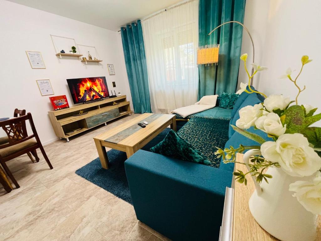 a living room with a blue couch and a fireplace at Sal Apart in Timişoara