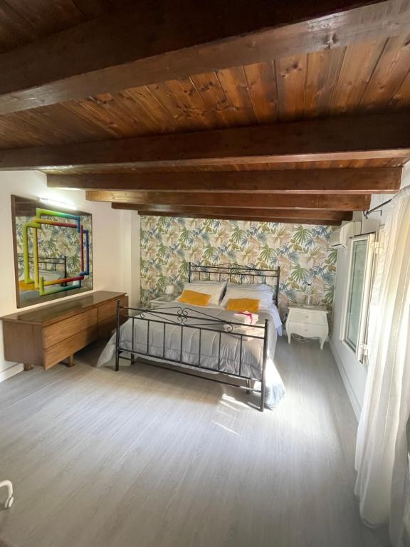 a bedroom with a bed and a wooden ceiling at La Zisa Holiday in Palermo